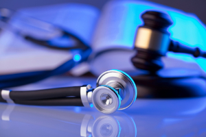Stethoscope and gavel. How your pre-existing conditions may affect your medical malpractice claim.