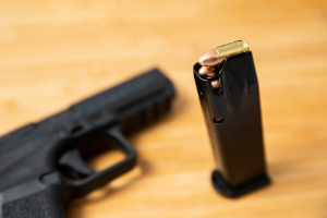 9mm. How possessing a firearm can affect other criminal charges.