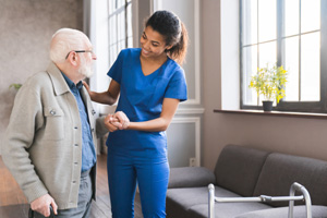 nurse helping senior old elderly man