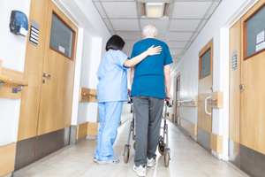 nurse helping elder man