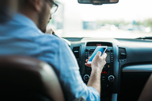 transportation concept man using phone while driving the car