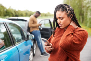 Female Motorist Involved In Car Accident Calling Insurance Company Or Recovery Service 