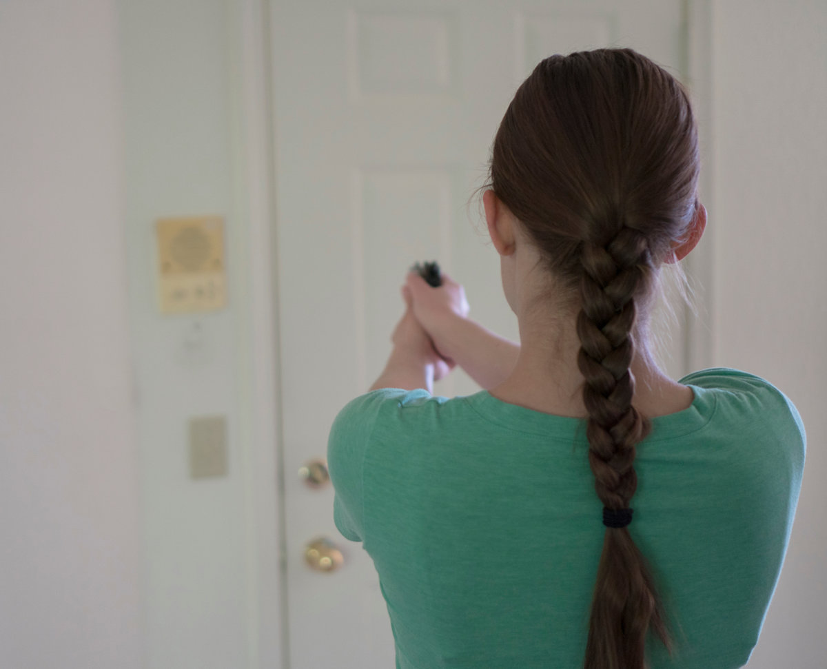 Woman pointing gun at door. Intruder concept.