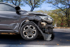 Hit-and-run accident damaged vehicle – RGSG Damaged black car after hit-and-run accident on city street